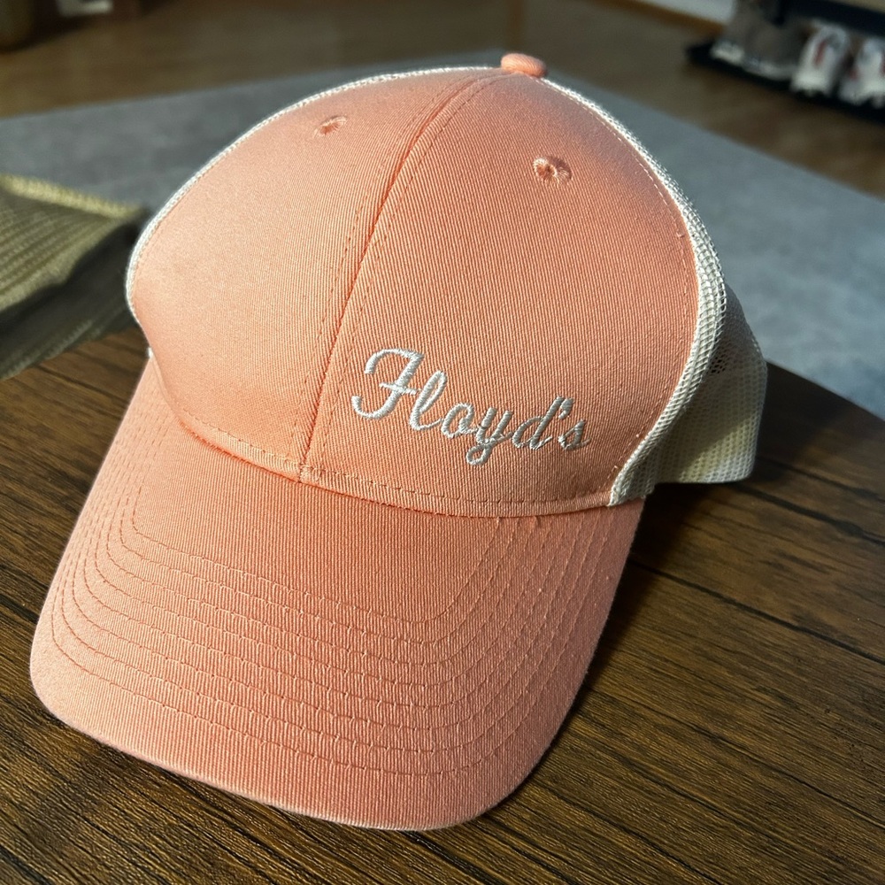 Salmon colored hat, snapback, Floyd’s stitched on it.